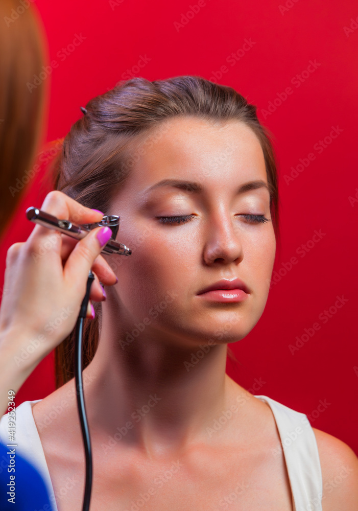 visagist making makeup for model with aerograph visagist making makeup for model with aerograph
