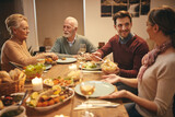 Happy man talking to his wife during family meal at dining table.