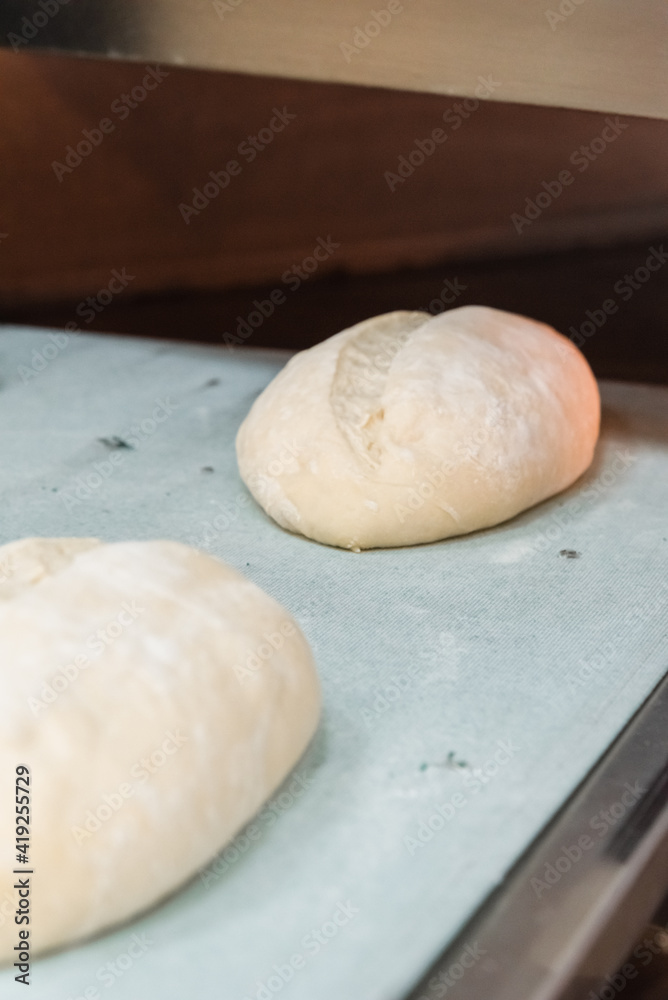 Baker making bread , man hands , kneading a dough , cooking coat.The concept of small bakeries, craft traditional bread