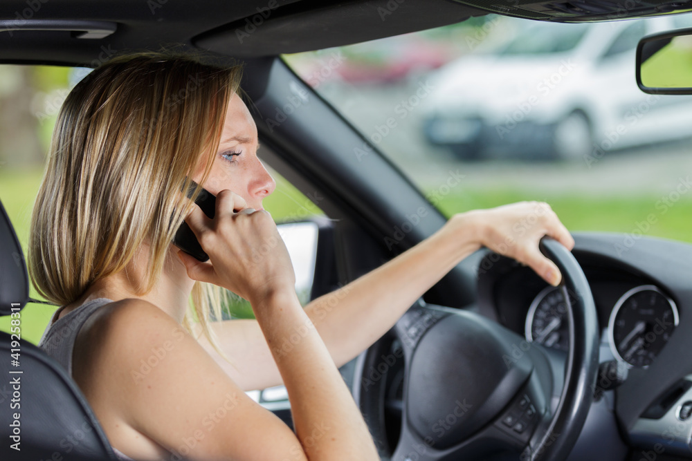 female driver talking on the phone
