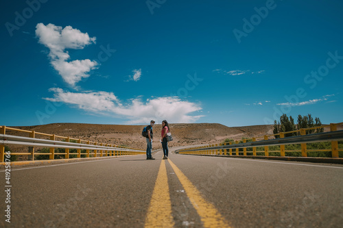 Traveler couple with backpack walking on route in Patagonia Argentina