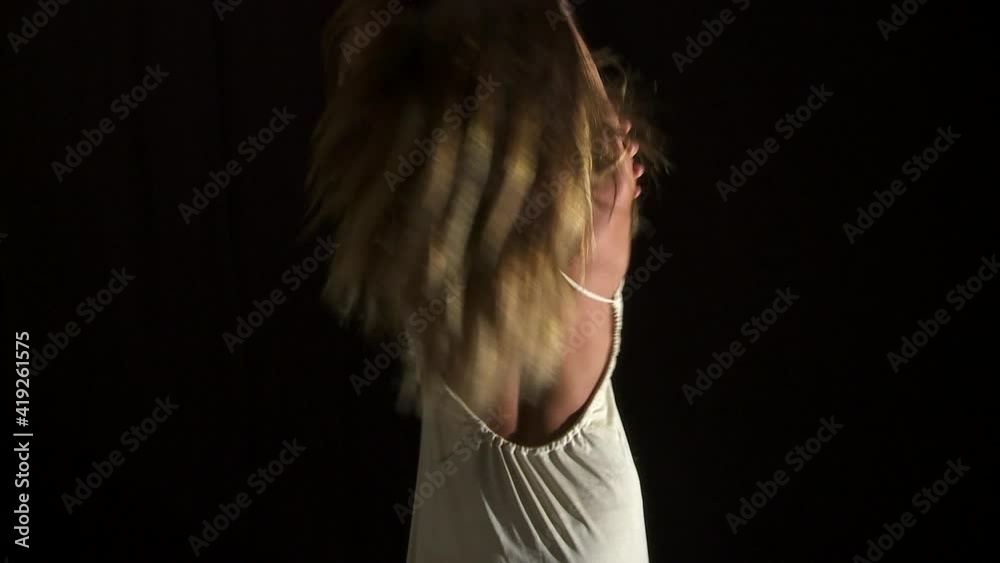 Woman alone with the white dress moving and dancing expressing her emotions