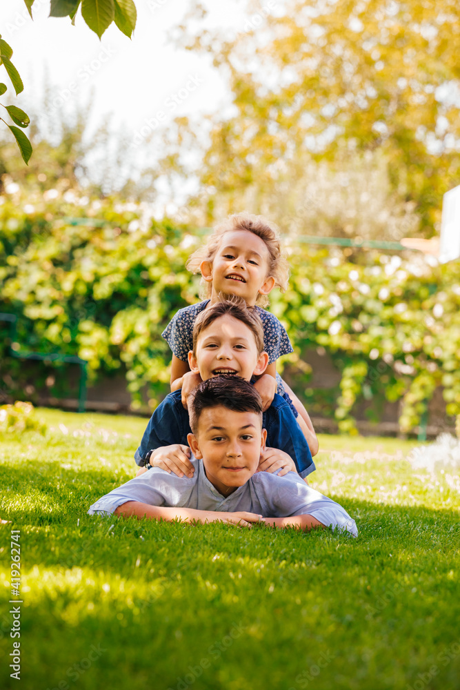 Portrait of three little children as a tower Portrait of three little children as a tower