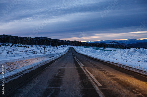 sunrise on a winter road in the mountains