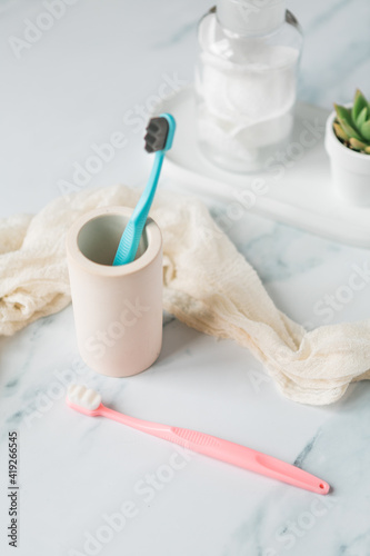 Fluffy toothbrushes in bathroom setting, modern bathroom