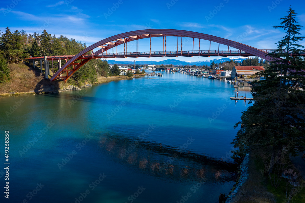 Fototapeta premium Rainbow Bridge in the Town of La Conner, Washington. Rainbow Bridge connects Fidalgo Island and La Conner, crossing Swinomish Channel in Skagit County. National Register of Historic Places. 
