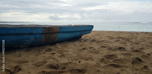 Vintage boat in Caribbean landscape.