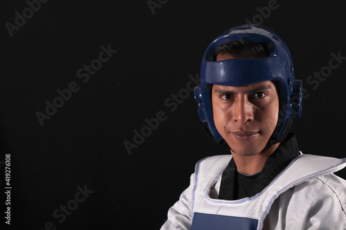 Latin Taekwondo player wearing blue helmet protection
