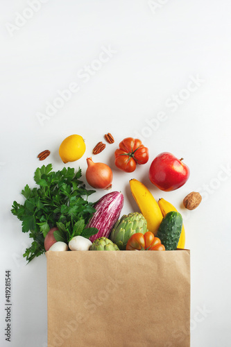 Fototapeta Naklejka Na Ścianę i Meble -  Delivery healthy food background. Healthy vegan vegetarian food in paper bag vegetables and fruits on white, copy space. Shopping food supermarket and clean vegan eating concept