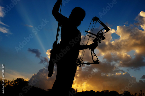 Silhouette of people playing archery © taffpixture