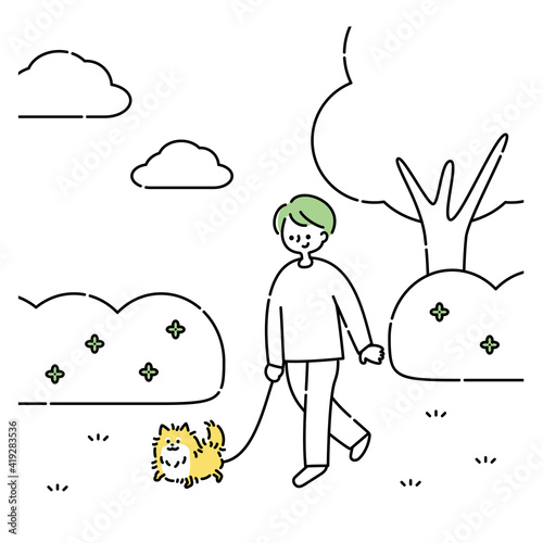 犬と公園を散歩する男性