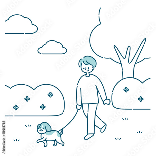 犬と公園を散歩する男性