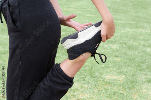 girl stretching her leg in the park