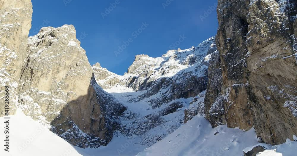 Mountain Aerial Landscape, flying over Hills and Forests covered in Snow after Snow fall in the Alps. Sella Mountain Rock face. Wilderness in Italy in Dolomites UNESCO World Heritage Mountain Aerial Landscape, flying over Hills and Forests covered in Snow after Snow fall in the Alps. Sella Mountain Rock face. Wilderness in Italy in Dolomites UNESCO World Heritage