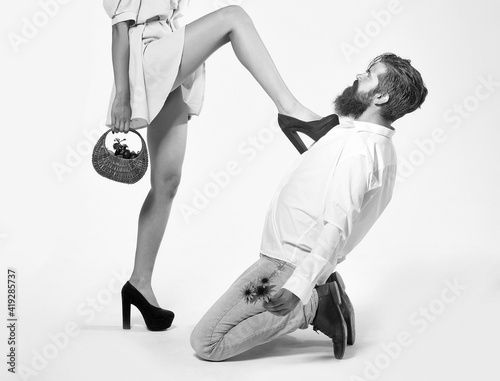 Man under a female heel. Role playing games of a sexy couple. Mistress seducer concept.