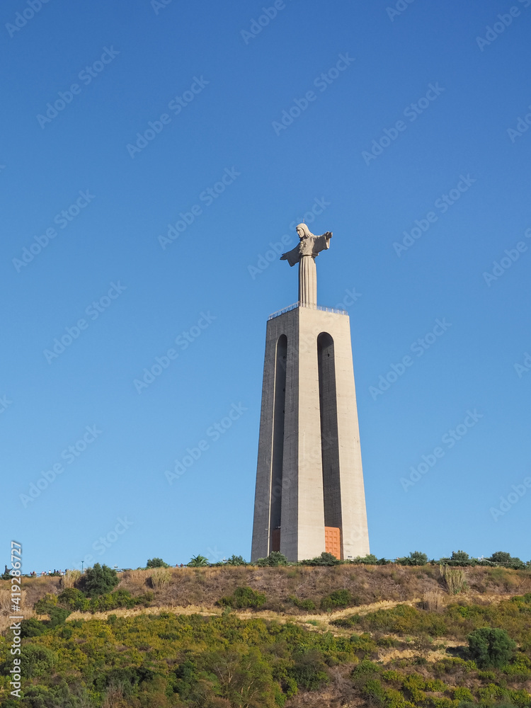 National Sanctuary of Christ the King or Santuário de Cristo Rei in blue sky background. Catholic statue Sacred Heart of Jesus Christ inspired by Rio's Christ the Redeemer. Lisbon, Portugal. National Sanctuary of Christ the King or Santuário de Cristo Rei in blue sky background. Catholic statue Sacred Heart of Jesus Christ inspired by Rio's Christ the Redeemer. Lisbon, Portugal.