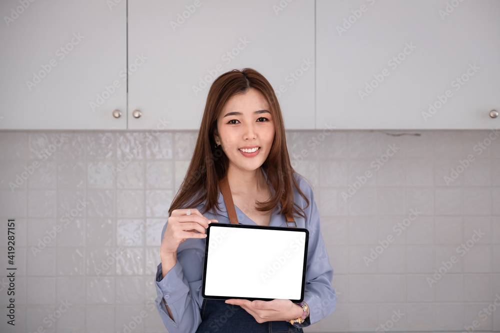 Businesswoman holding tablet blank screen with smile.