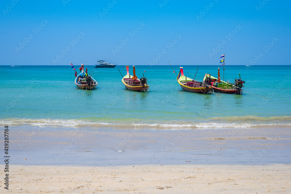 Long tail boats on Kamala beach on Phuket island in Thailand.