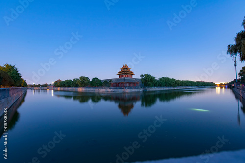 corner building of forbidden city with reflection