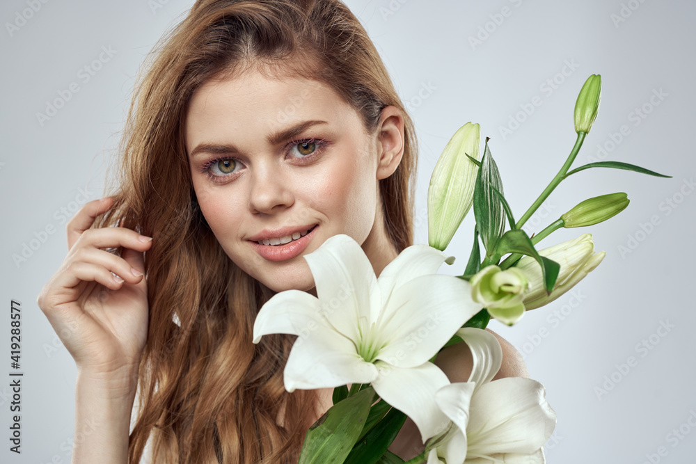 Emotional woman with flowers spring model naked shoulders clear skin Emotional woman with flowers spring model naked shoulders clear skin