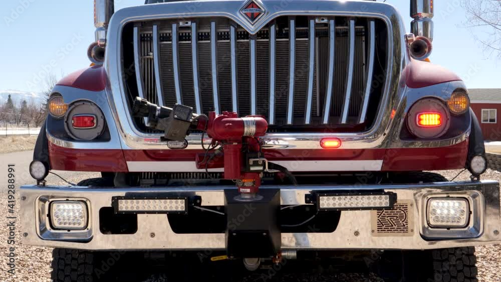 Closeup Fire Engine front end grill with emergency lights flashing as it responds to local emergency