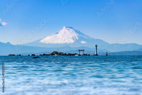 Seascape of Mt.Fuji with torii and lighthouse in the noon at Manase Coast. Yokosuka City, Kanagawa Prefecture, Japan. 