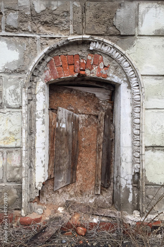 the window of an old ruined building, clogged with boards