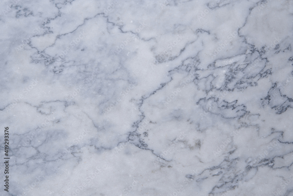 the texture of a gray marble slab made of natural stone. background of the marble surface with a blue tint