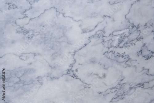the texture of a gray marble slab made of natural stone. background of the marble surface with a blue tint