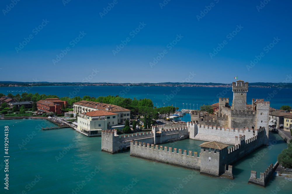 Fototapeta Sirmione, Lake Garda, Italy. Aerial view of Sirmione Castle. Blue sky in the background