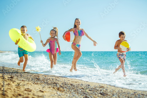 Children have fun on the sandy beach in summer. High quality photo.