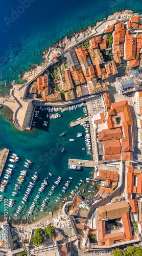 Aerial overhead drone shot of Dubrovnik old town port in Adriatic sea in Croatia summer