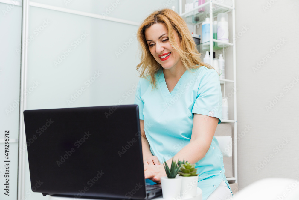 Young female doctor talking to patient online from medical office. Physician consulting client on video chat laptop at hospital Young female doctor talking to patient online from medical office. Physician consulting client on video chat laptop at hospital