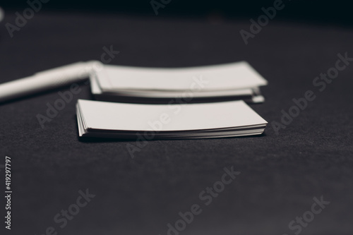 business cards on dark table and pen office mockup