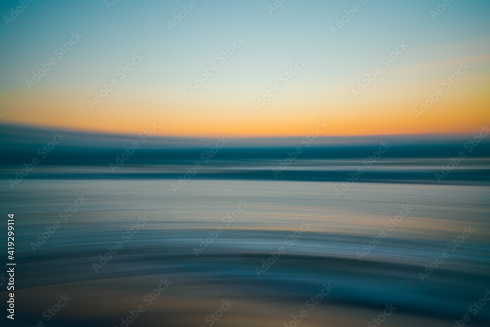 Obraz premium Golden hour on the beach, abstract seascape background, line art, soft blur, water surface, yellow, blue, turquoise colors