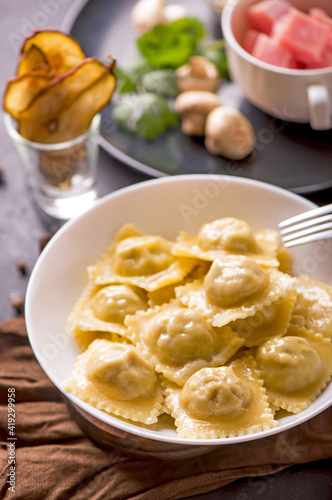 ravioli with spinach and ricotta cheese on a wooden table.