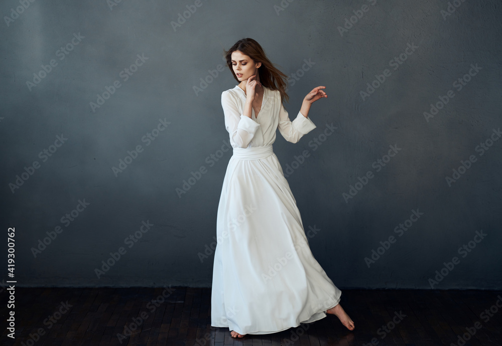 Fototapeta premium Woman in white dress dance performance luxury glamor gray background