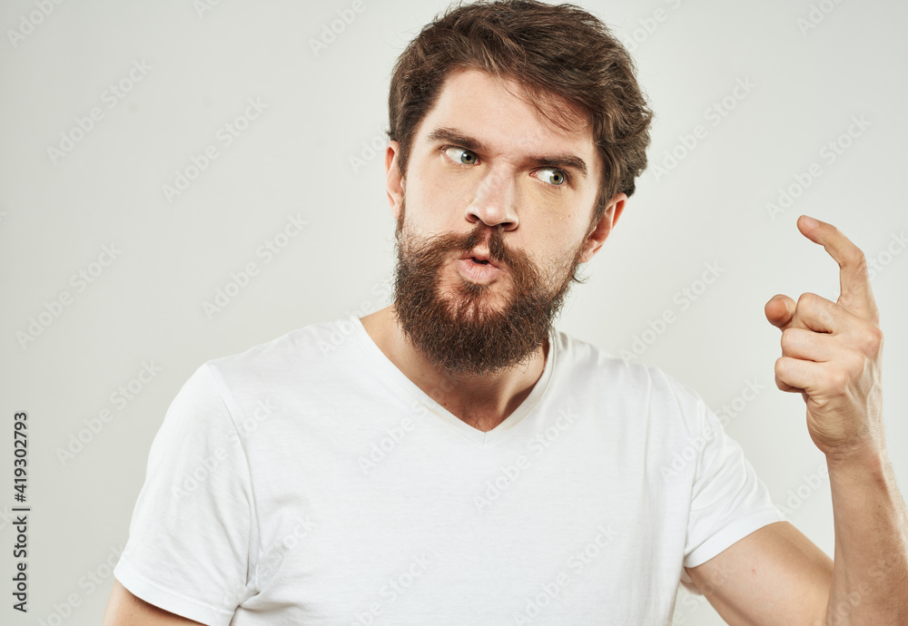 The guy in the T-shirt shows the index finger and emotions model an indignant look The guy in the T-shirt shows the index finger and emotions model an indignant look