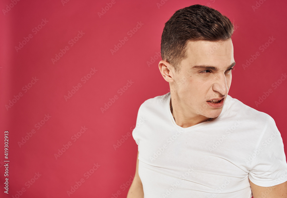 emotional man in white t-shirt studio dissatisfaction red background emotional man in white t-shirt studio dissatisfaction red background