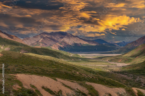 Picturesque Mountains of Alaska in summer. Snow covered massifs, glaciers and rocky peaks. Beautiful natural background.