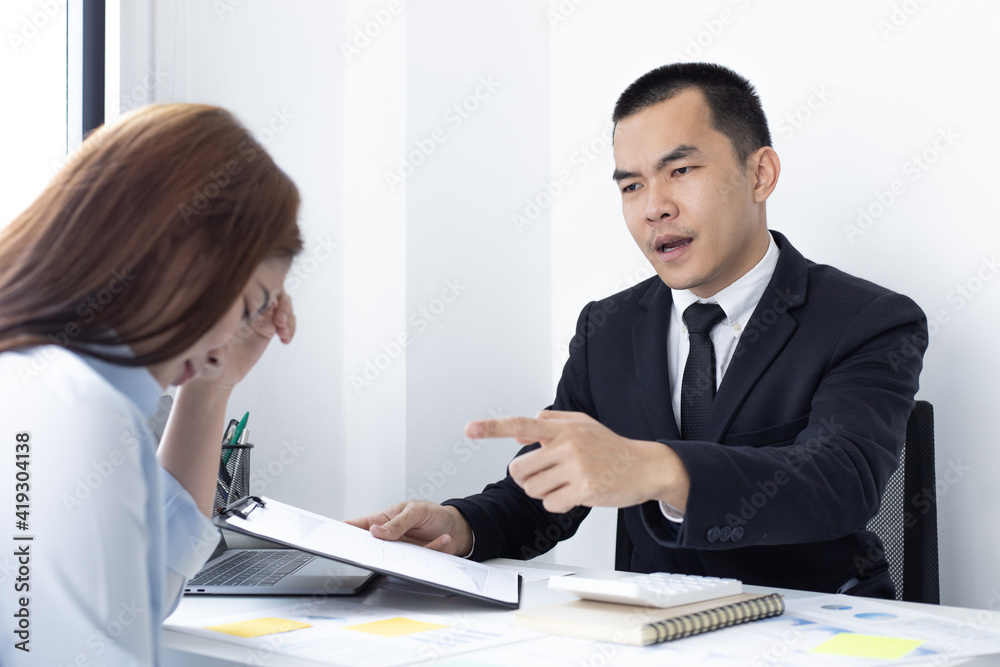 Warning offenders, supervisor in a black suit warns or scolds a woman finance worker for the wrong operation, Punishment for malfunctions or failures. Warning offenders, supervisor in a black suit warns or scolds a woman finance worker for the wrong operation, Punishment for malfunctions or failures.