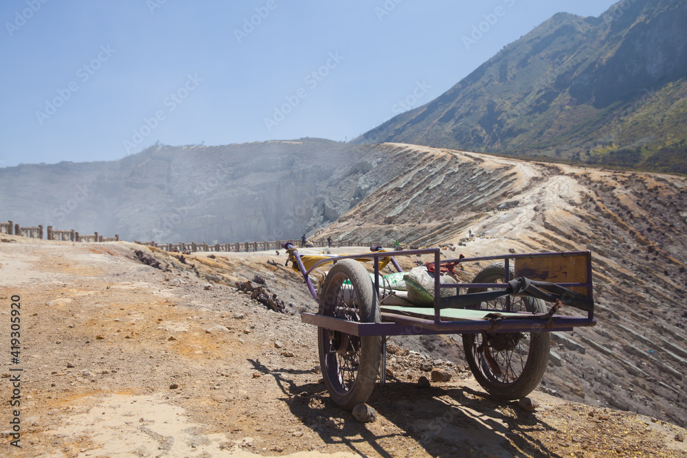 Obraz premium old cart on a mountain waiting for carrying sulfur down from a mountain. Ijen volcano on Java island.