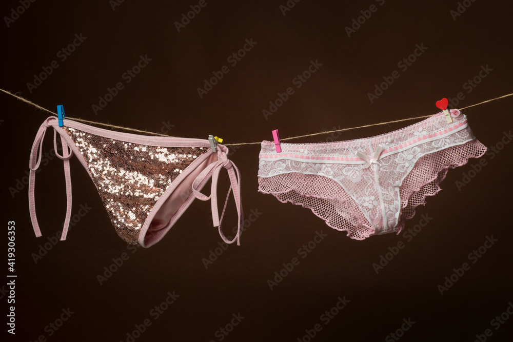 Female lingerie on rope. Female underwear. Woman pants on clothesline. Colorful erotic panties. Female lingerie on rope. Female underwear. Woman pants on clothesline. Colorful erotic panties.