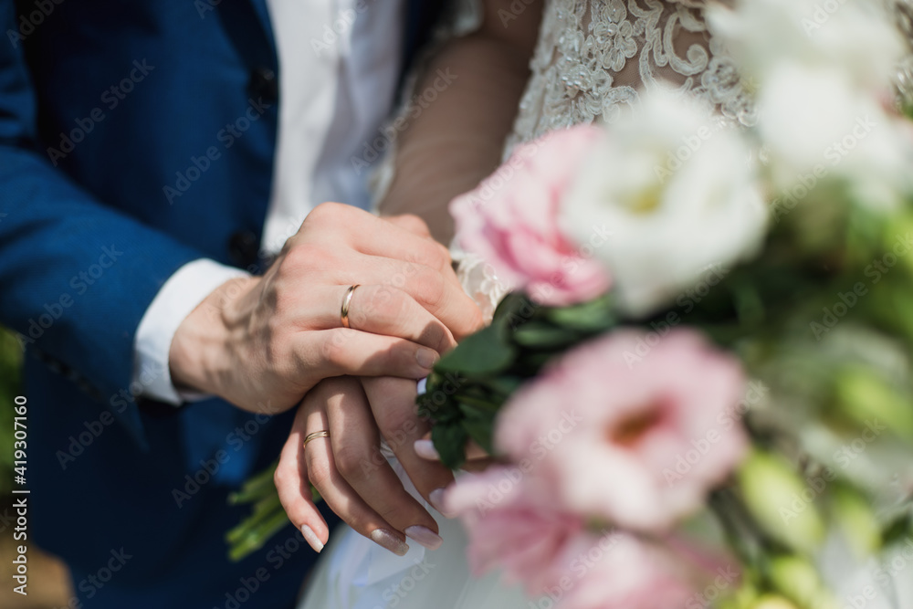 the bride holds her beautiful wedding bouquet with gentle hands