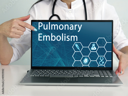  Pulmonary Embolism inscription on the screen. Close up Hematologist hands holding black laptop.