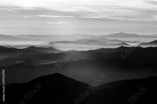 Mist and fog between valley and layers of mountains and hills atr sunset in Umbria (Italy)