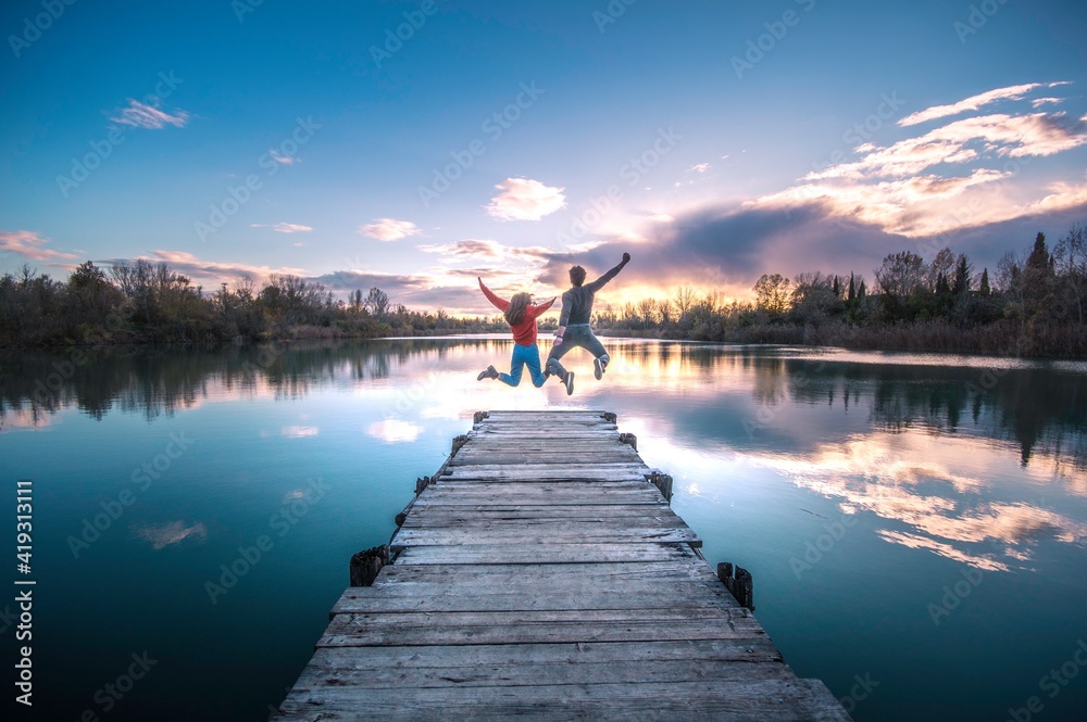couple enjoying on the lake  with blue sky making a beautiful landscape
