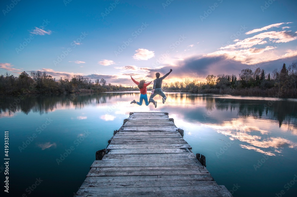 couple enjoying on the lake with blue sky making a beautiful landscape
couple enjoying on the lake with blue sky making a beautiful landscape