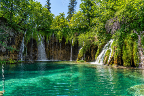 Waterfall with turquoise water in the Plitvice Lakes National Park  Croatia.