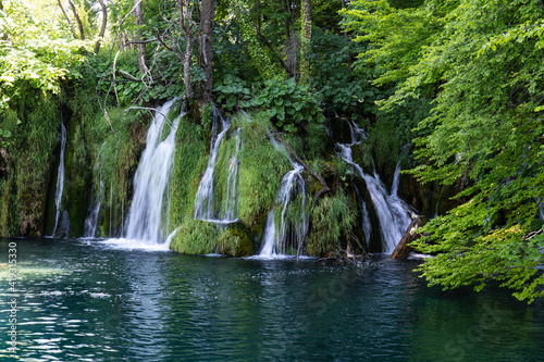 Waterfall with turquoise water in the Plitvice Lakes National Park, Croatia. © rudiernst